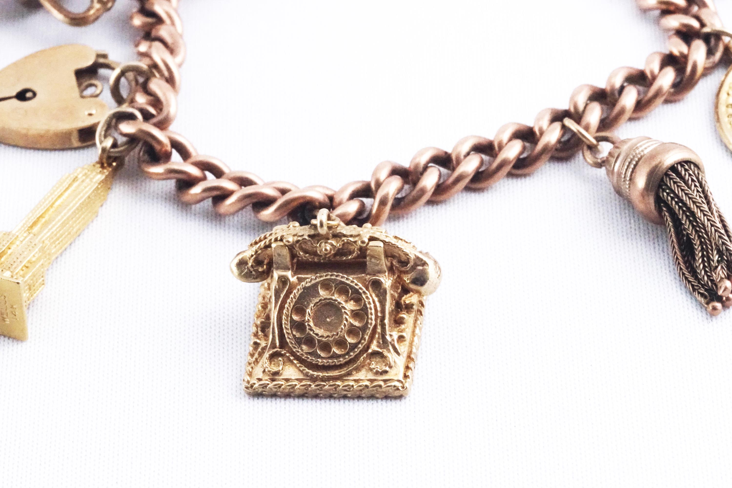 A rose gold curb link charm bracelet with padlock and safety chain having six assorted charms - Image 2 of 3