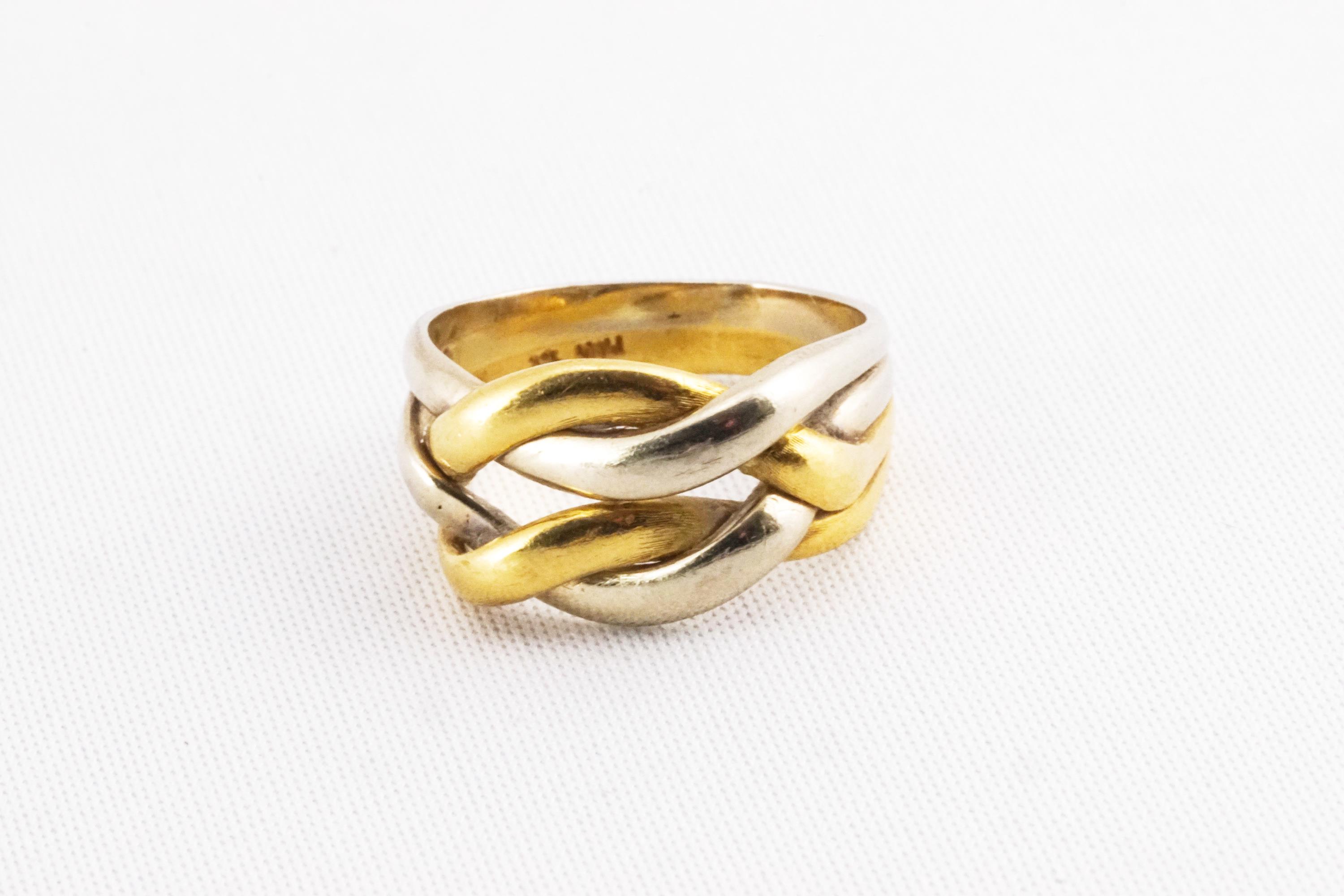 A yellow and white metal puzzle style dress ring. No hallmark - stamped 18K Italy for 18ct gold.