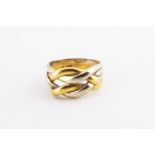 A yellow and white metal puzzle style dress ring. No hallmark - stamped 18K Italy for 18ct gold.