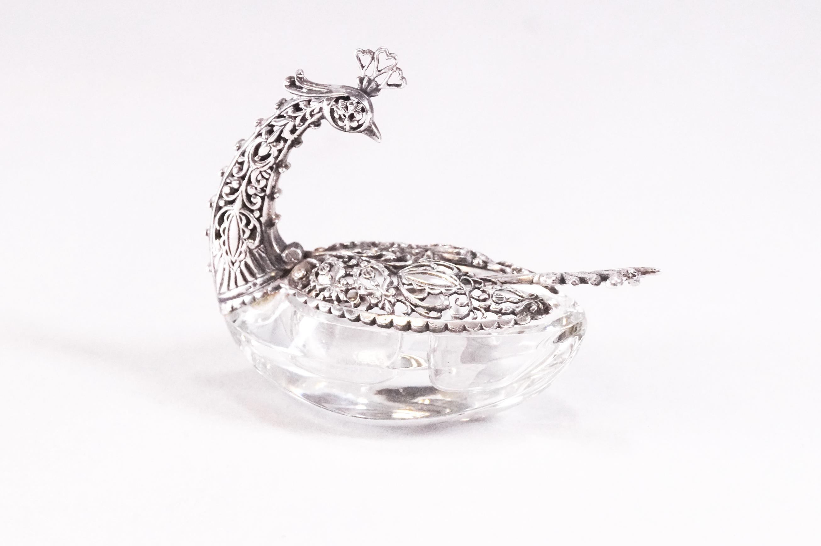 A pair of filigree white metal and glass table salts in the form of a swan with folding wings