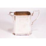 A George II style silver cream jug, of tapered rectangular cut cornered form,