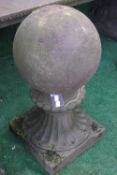 A pair of reconstituted stone plain ball finials on fluted trumpet square bases 66cm