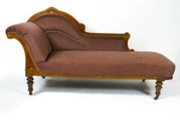 A Victorian walnut and boxwood inlaid show frame chaise longue on turned tapering legs