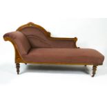 A Victorian walnut and boxwood inlaid show frame chaise longue on turned tapering legs