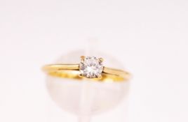 A yellow metal four claw single stone ring together with a loose round brilliant diamond