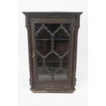 A 19th century carved oak corner cabinet with overall decoration with stylised flower heads