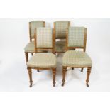 A set of four oak framed chairs by Maple and Co with upholstered backs and seats