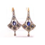 A yellow and white metal ornate design pair of drop earrings set with sapphires and diamonds.