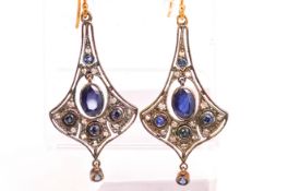 A yellow and white metal ornate design pair of drop earrings set with sapphires and diamonds.