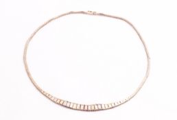 A three colour gold graduated collar necklace. Push in clasp with figure of eight safety catch.