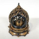 A carved soapstone burner of pierced form,