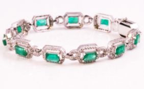 A white metal line bracelet consisting of repeating links each set with a rectangular faceted cut