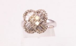 A white metal cluster ring in the style of a clover