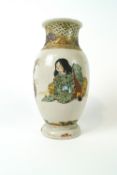 A Japanese earthenware vase decorated in Satsuma style with two figures and a vase of flowers,