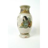 A Japanese earthenware vase decorated in Satsuma style with two figures and a vase of flowers,