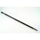 A blackened carved wood walking cane, possibly African,