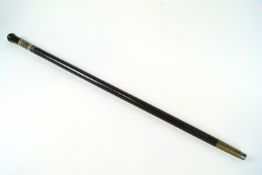 A blackened carved wood walking cane, possibly African,