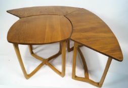 A set of Ercol sectional light elm occasional tables,