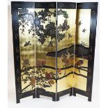A Japanese Japanned four fold screen, decorated with birds in a landscape on a gilt ground,