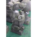 A pair of reconstituted stone sejant heraldic dogs,