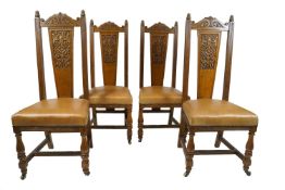 Set of four oak dining chairs with carved arched cresting rail above a carved solid splat