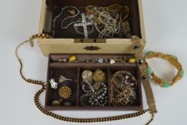 A jewellery case containing a large selection of costume jewellery, to include earrings, brooches,