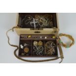 A jewellery case containing a large selection of costume jewellery, to include earrings, brooches,