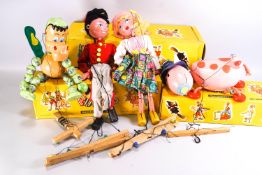 Four Pelham puppets, comprising : Tyrolean Girl, Fritzi, Baby Dragon and Cow Ermintrude, boxed,