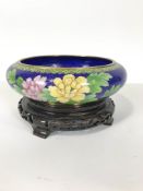 A modern Chinese cloisonne shallow bowl and carved ebanised stand ,