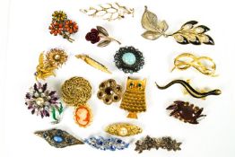 A collection of twenty costume brooches of variable designs.