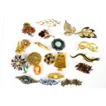 A collection of twenty costume brooches of variable designs.