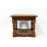 A mahogany cross banded square two tier occasional table on turned legs,
