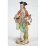A porcelain Meissen style figure of a grape seller,