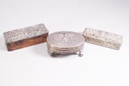 An oval silver jewel casket, raised on four lion paw feet,