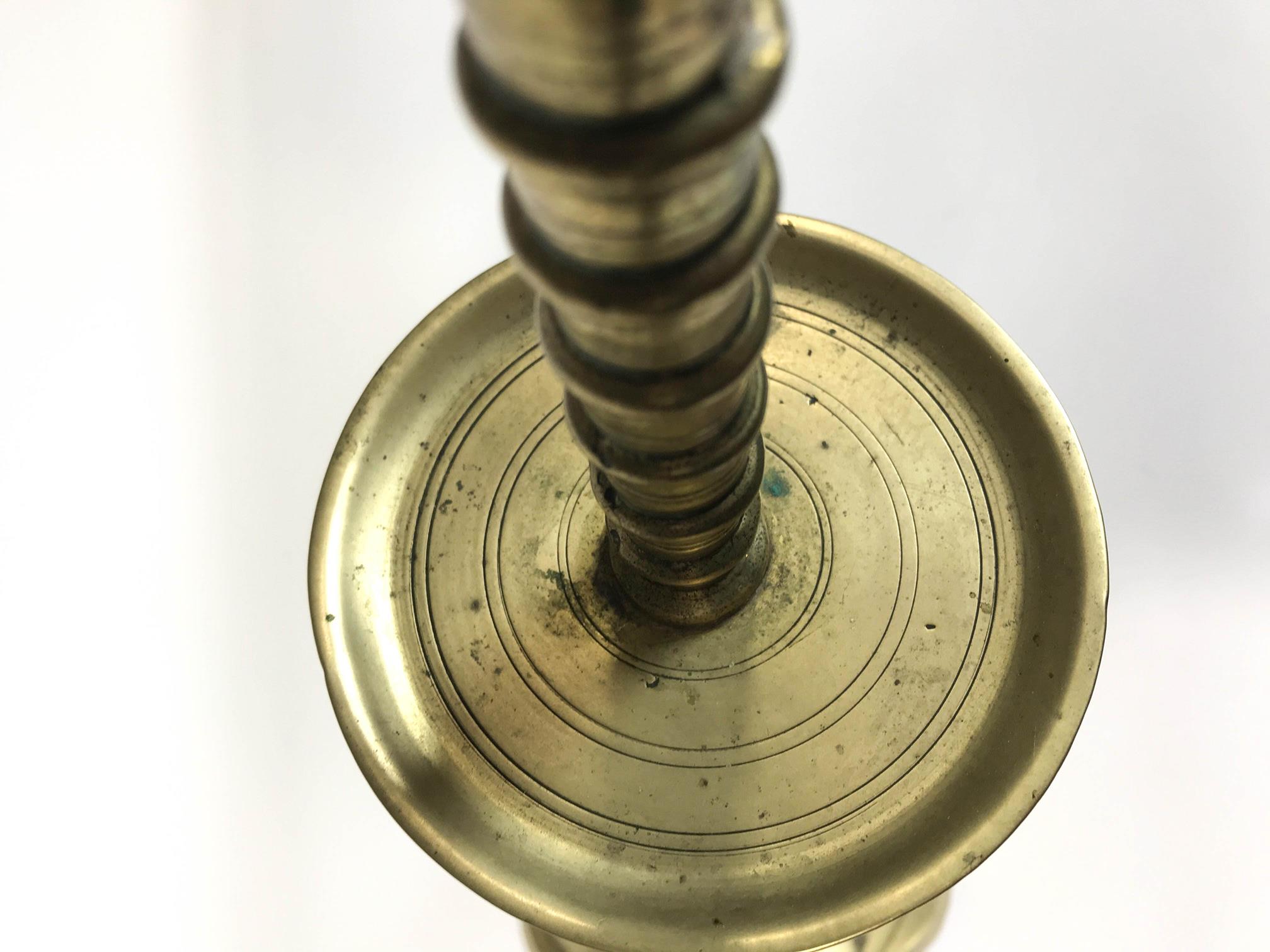 A late 18th/ early 19th century brass candlestick with flared drip pan - Image 2 of 4