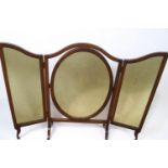 A mahogany framed triptych dressing table with oval swing frame central section on flared feet,
