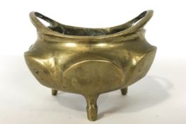 A Chinese gilt bronze small two handled censor, of lobed circular form, on three feet,