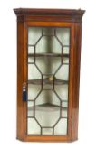 A mahogany glazed hanging corner cupboard, in George III style,