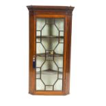 A mahogany glazed hanging corner cupboard, in George III style,