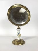 A brass and porcelain-mounted vanity mirror, the baluster porcelain stem printed with a kingfisher,