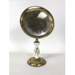 A brass and porcelain-mounted vanity mirror, the baluster porcelain stem printed with a kingfisher,