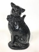 A black painted cast iron door stop modelled as a cat,