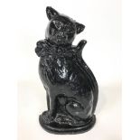 A black painted cast iron door stop modelled as a cat,
