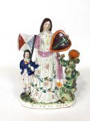 A Staffordshire pottery figure group of Band of Hope beside a tree trunk spill vase