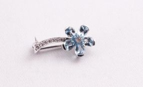 A white metal floral brooch set with pear cut aquamarines and finished with diamonds.