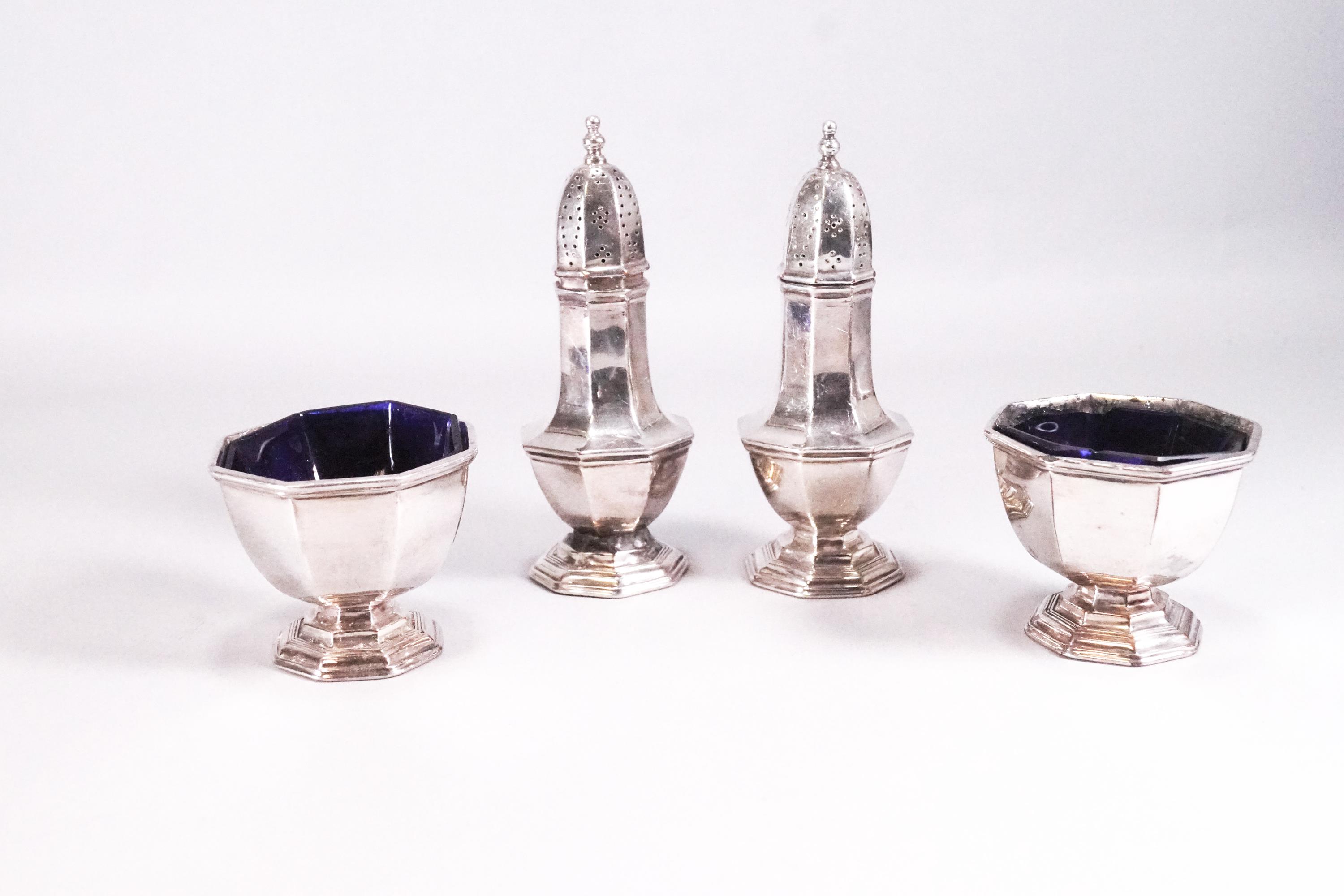 A silver plated five piece cruet set in the George I octagonal style, the casters,