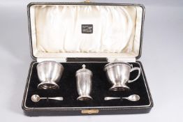 A cased silver five piece cruet set, of plain rounded form, with an applied swag border,