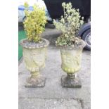 A pair of reconstituted stone urn planters of chalice form,
