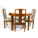 A Chinese rosewood extendable circular dining table with six dining chairs and 2 carvers,