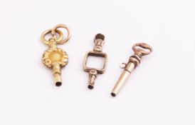 Three gold coloured pocket watch keys